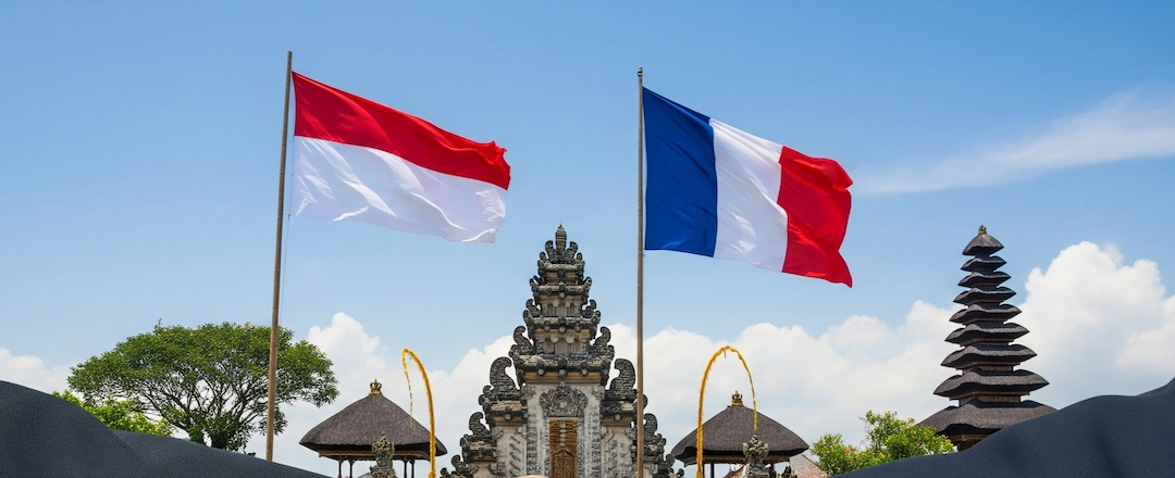 Symbolism of Bali-Franch Strengthen Connection; handshake, flag and Bali's nature as background