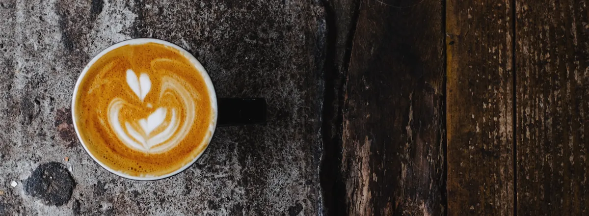 HERO-Sized Image of Coffee on a Rustic Table in Bird Eye View
