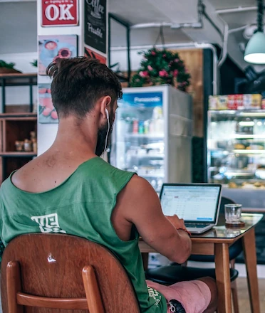 Digital Nomad Working in Cozy Coffee Shop