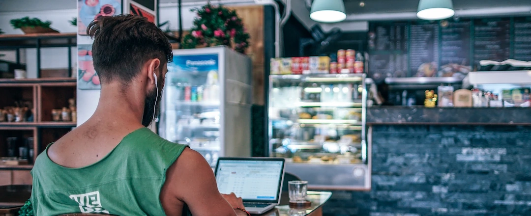 Digital Nomad Working in Cozy Coffee Shop