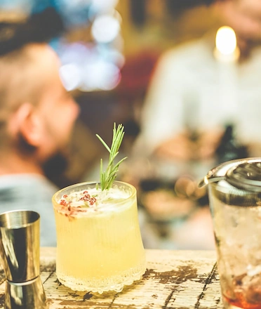 Craft Cocktails With People Chatting On The Background