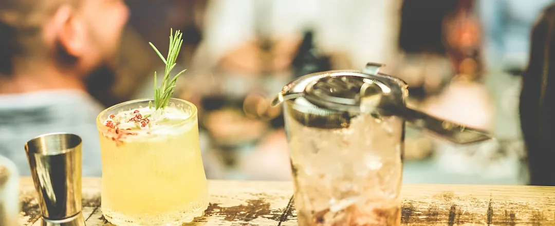 Craft Cocktails With People Chatting On The Background