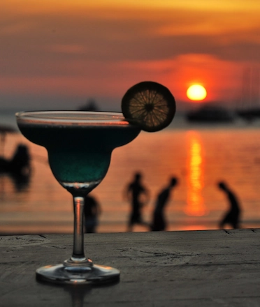 Cocktail with Scenic Sunset on the Background