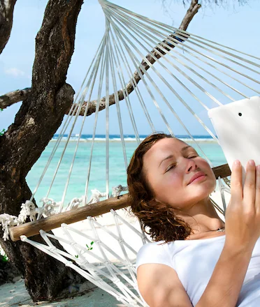 Caucasian Woman Chilling On A Hammock On Bali Beach