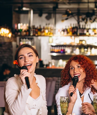 Women Enjoying Karaoke in a Bar