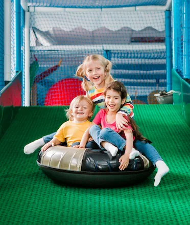 Kids Playing Slides in Playground Park