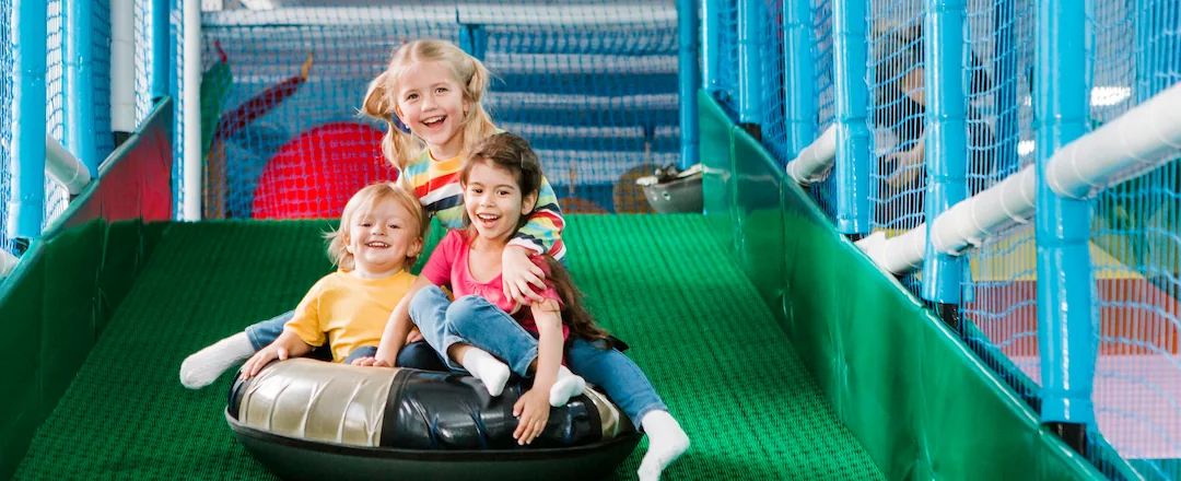 Kids Playing Slides in Playground Park