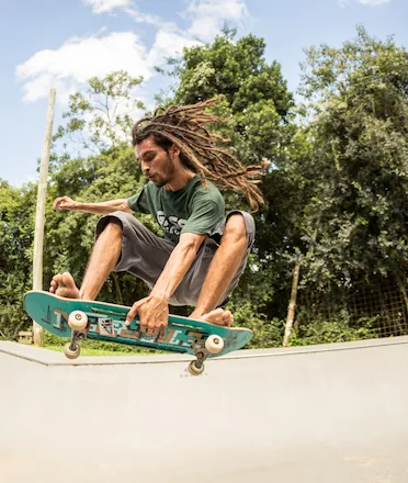 Skateboarder Hovering Doing Trick in Skatepark Ramp
