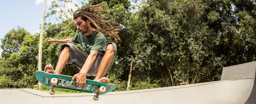 Skateboarder Hovering Doing Trick in Skatepark Ramp
