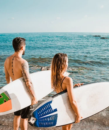 Man and Woman Ready to Surf