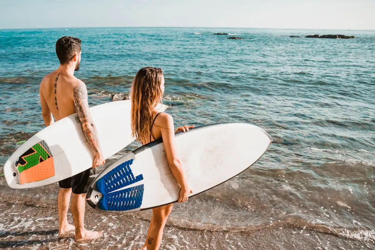 Man and Woman Ready to Surf