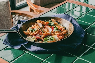 Table for Four, Paella for More: Adriana’s Paella Overload Brings People Together