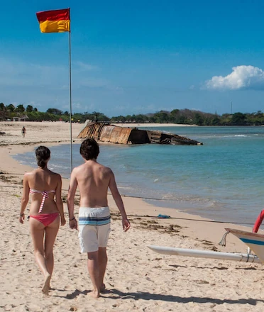 Couple walking on Mengiat Beach Nusa Dua's White Sandy Shore