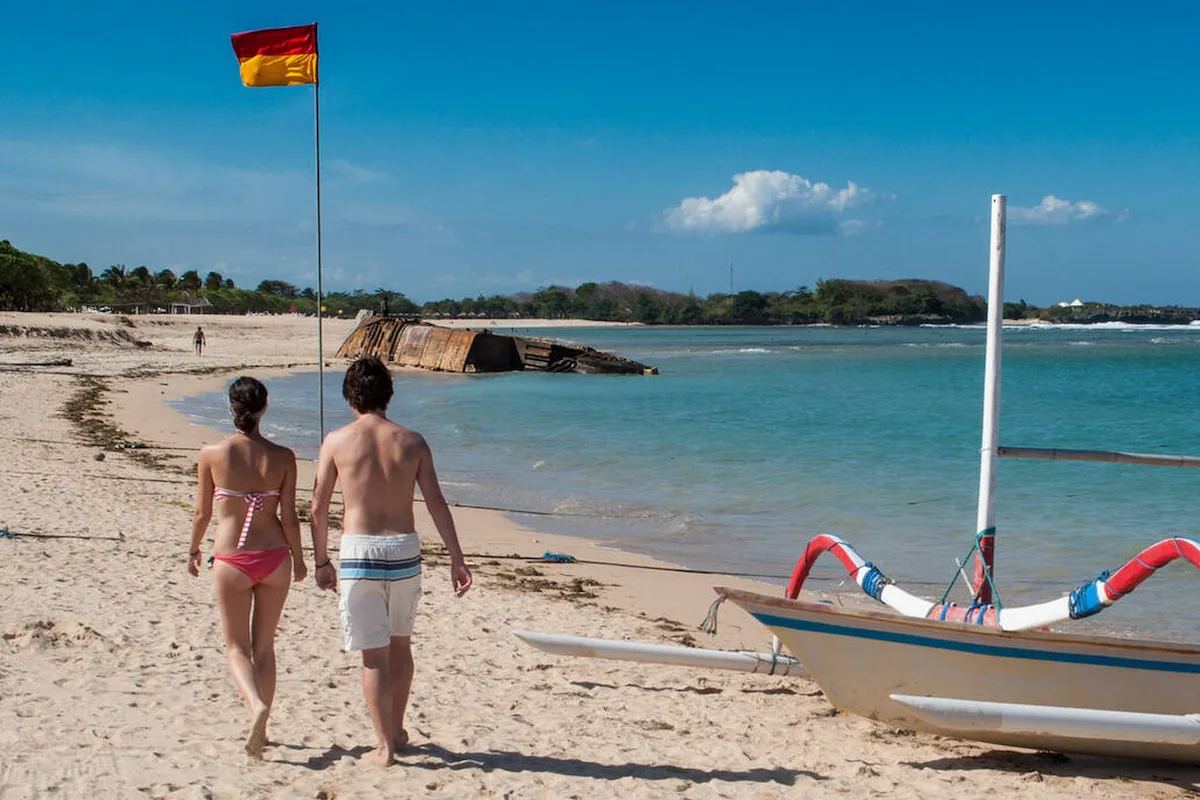 Couple walking on Mengiat Beach Nusa Dua's White Sandy Shore