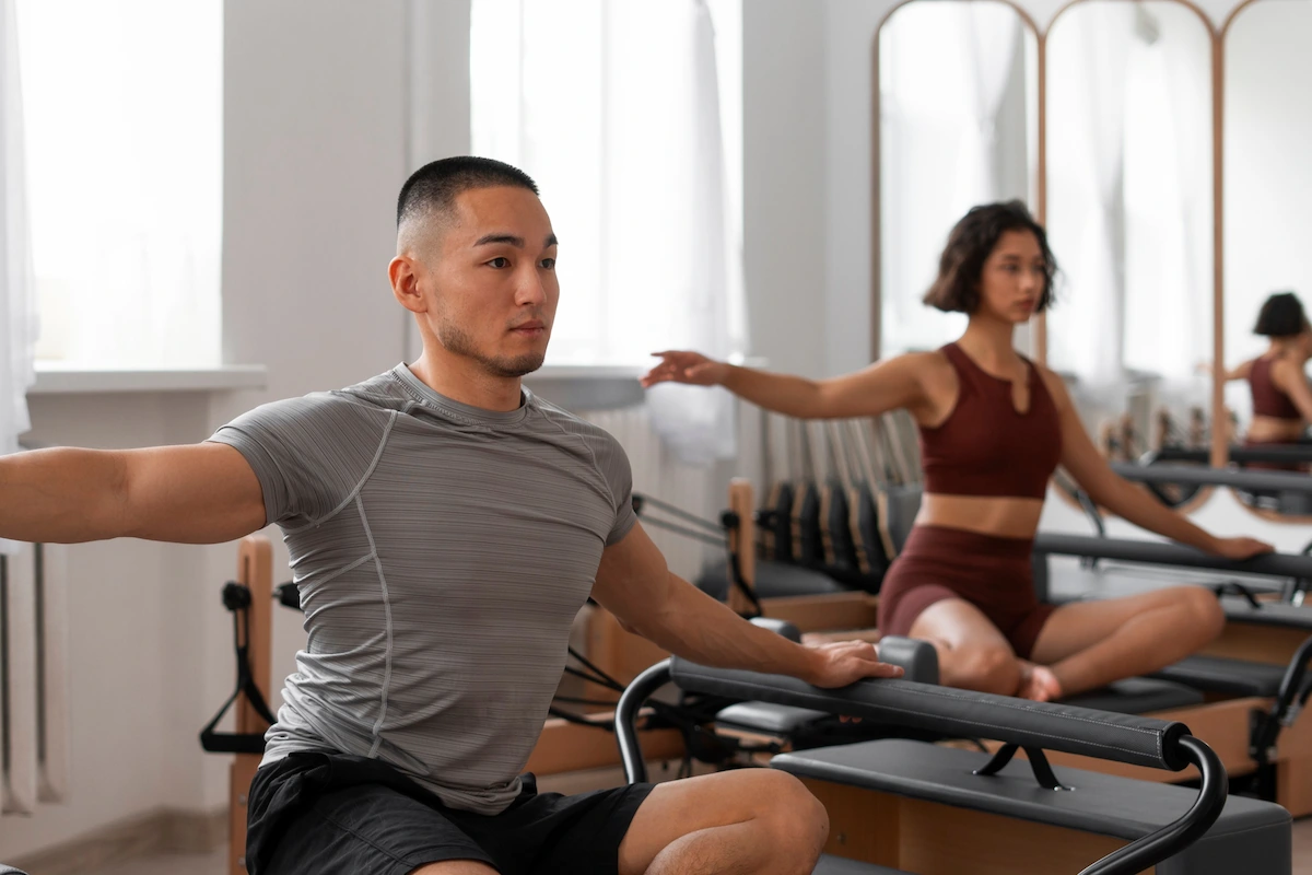 Men and Women doing Pilates Reform Class