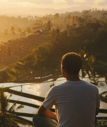 Man Watching Gorgeous Sunrise on Bali's Rice Terrace