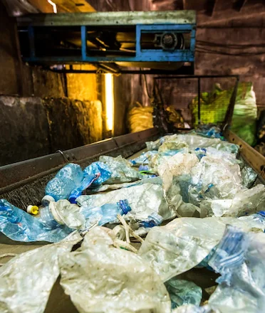 Plastic Waste on Conveyor Belt in Recycle Factory
