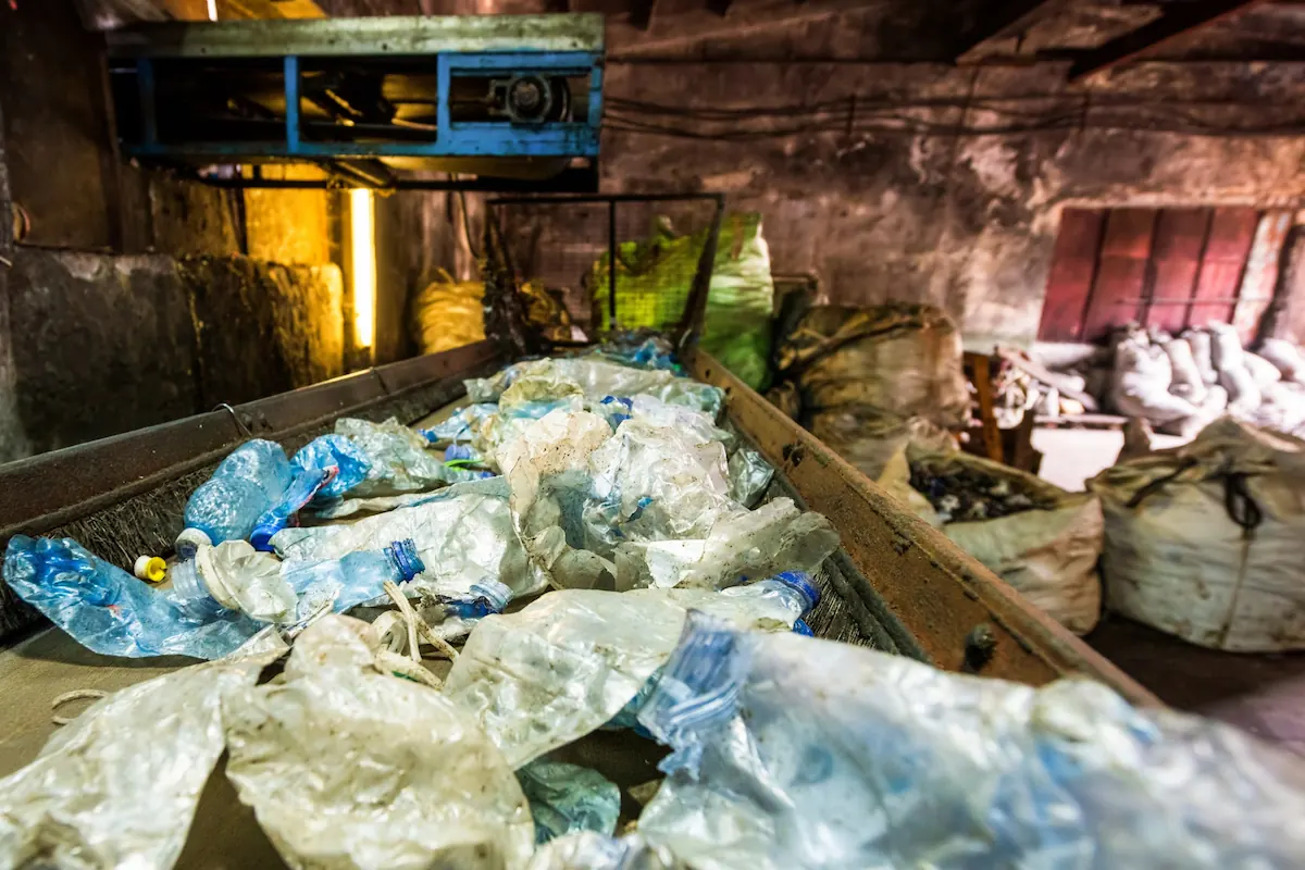 Plastic Waste on Conveyor Belt in Recycle Factory