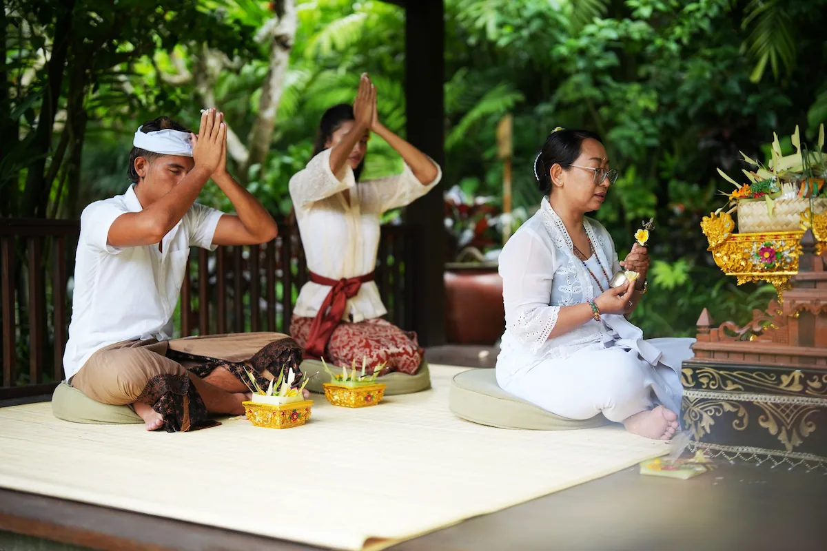 Tourist Praying With Female Mangku in Westin Ubud