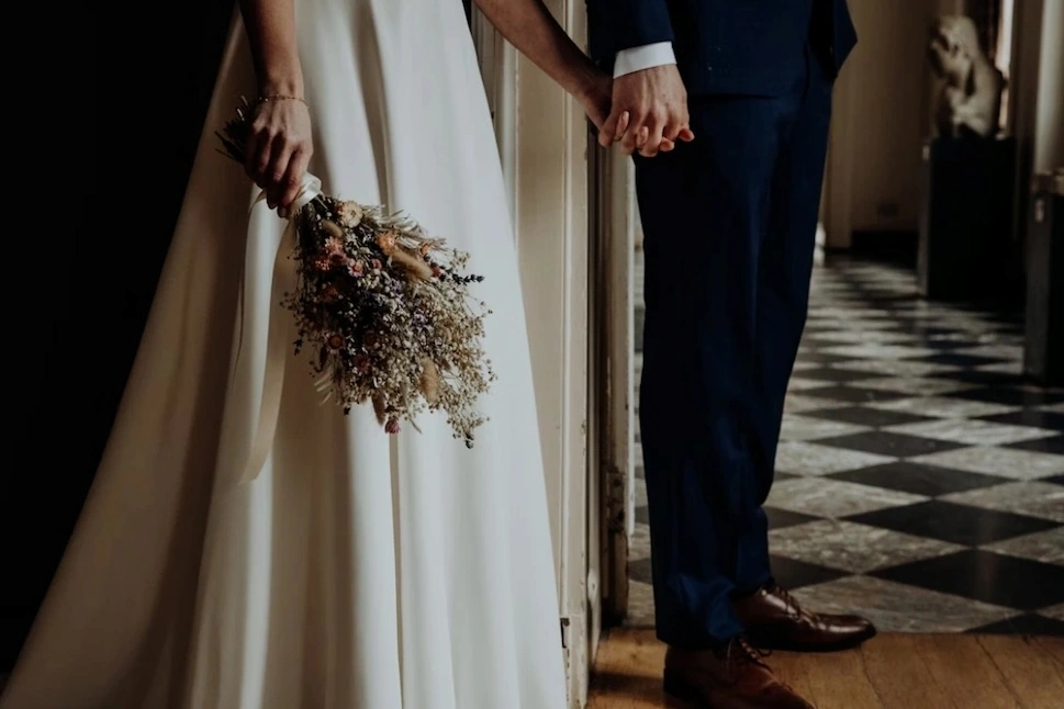 a couple at the wedding wearing wedding dress and tux