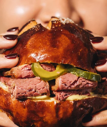 Woman Eating BB52 Signature Burger