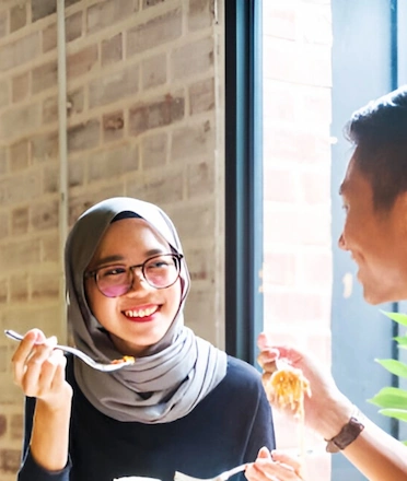 Moslem Man and Woman Eating At Halal Restaurant