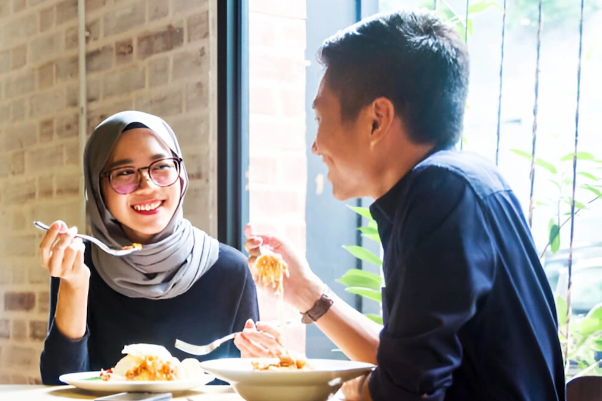 Moslem Man and Woman Eating At Halal Restaurant