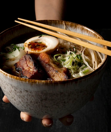 Delicious Ramen Handed by Person