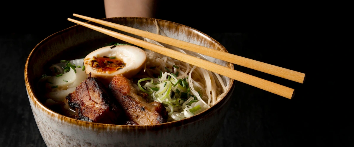 Delicious Ramen Handed by Person