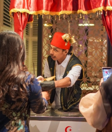 A man gives coffee to a lady