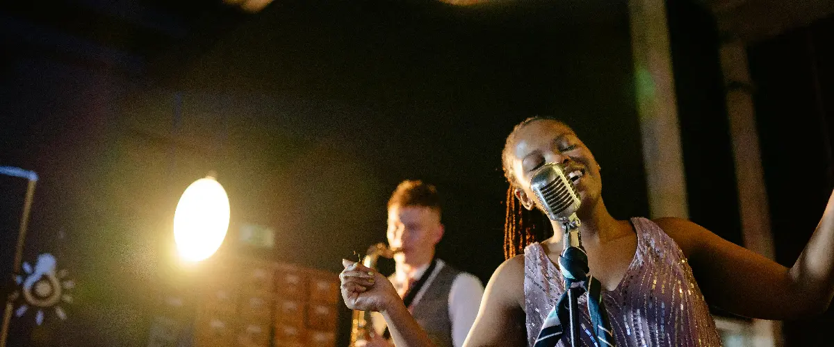 Live jazz performance with a female singer and saxophonist on stage