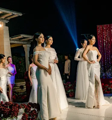Bridal fashion show featuring models in elegant white wedding gowns