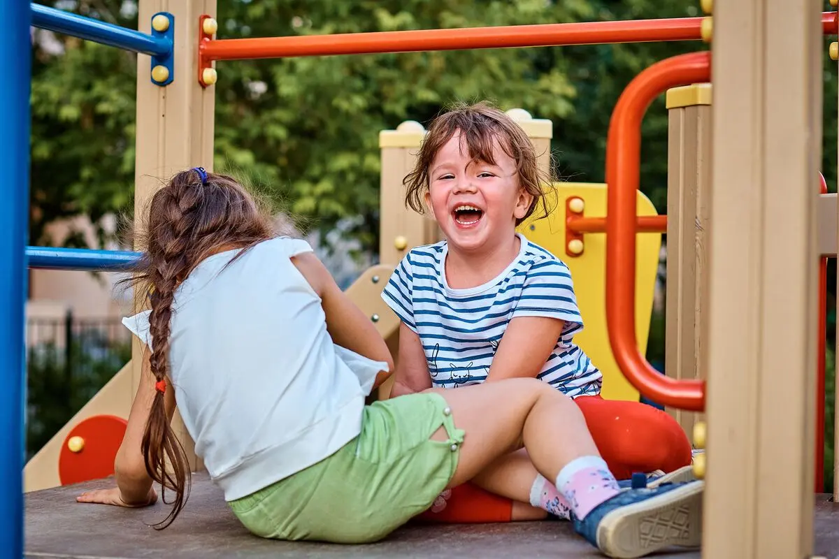 little kids playing happily in the playground