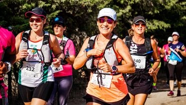Running event participants on a forest trail
