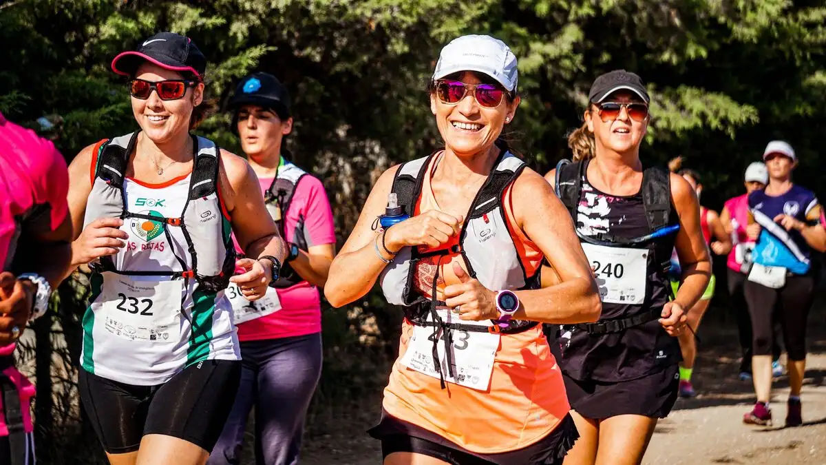 Running event participants on a forest trail