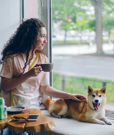 A_woman_with_a_dog_in_a_cafe