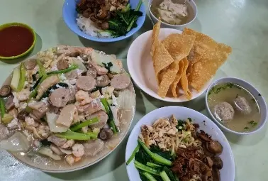 a bowl of noodle and other chinese food