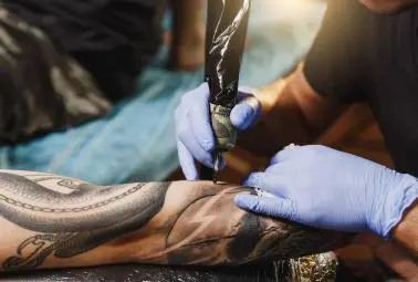 needle tattoo on arm