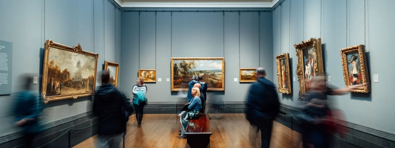 people_looking_at_paintings_in_a_museum