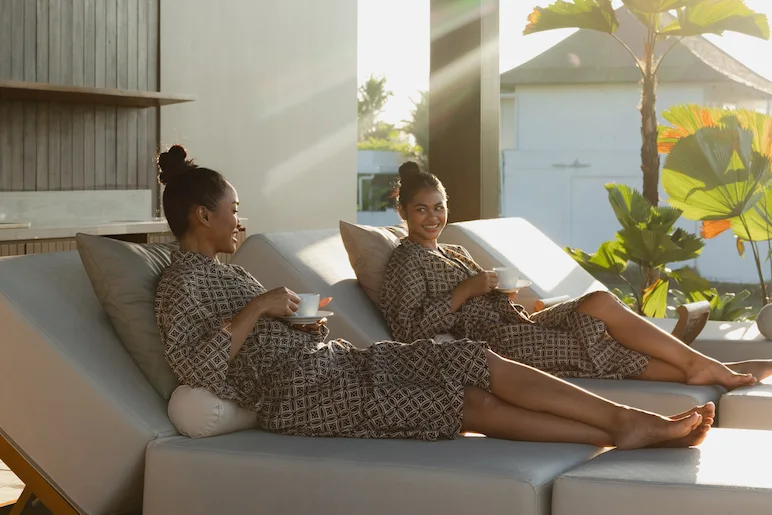 Two girls laying on the daybead