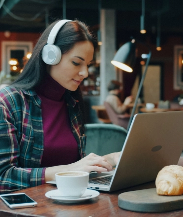 Woman_using_a_laptop_in_a_cozy_café