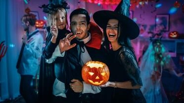 family wearing different costumes celebrating halloween