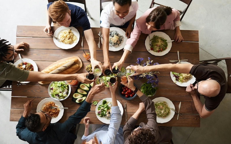 people having brunch cheering together