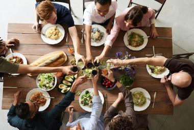 people having brunch cheering together